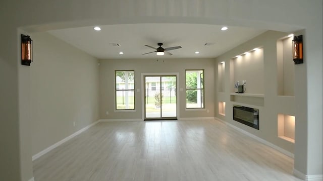 2716 Garapan St, Houston, TX 77091 - unfurnished living room featuring baseboards, ceiling fan, light wood-style floors, and recessed lighting