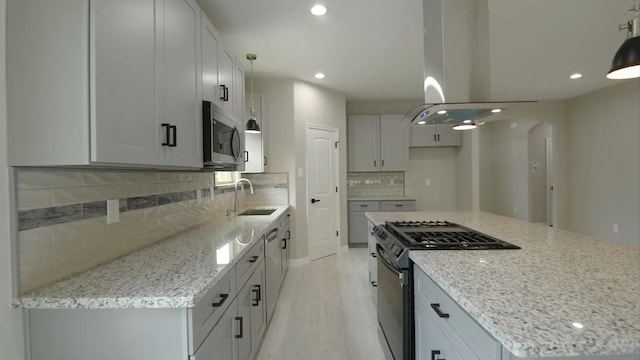 2716 Garapan St, Houston, TX 77091 - kitchen with appliances with stainless steel finishes, a sink, island range hood, recessed lighting, and light stone counters