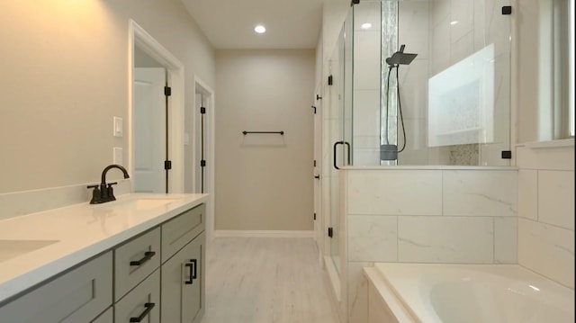 2716 Garapan St, Houston, TX 77091 - full bath featuring a shower stall, a garden tub, baseboards, double vanity, and recessed lighting