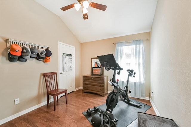 workout area with vaulted ceiling, ceiling fan, wood finished floors, and baseboards