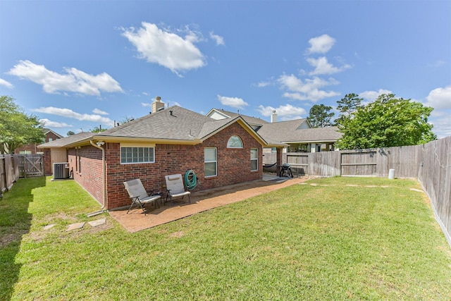 rear view of property with central AC unit, brick siding, a patio area, a shingled roof, and a chimney