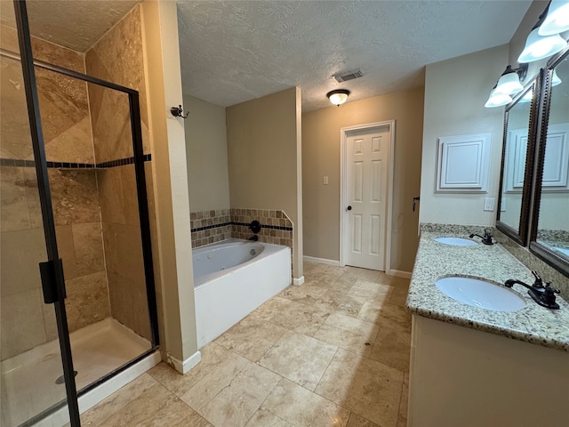 3505 Stonegate Cir, Pearland, TX 77584 - full bath featuring a bath, a shower stall, a textured ceiling, double vanity, and baseboards