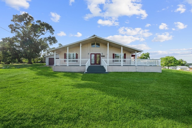 381 N Shady Oaks Dr, Point Blank, TX 77364 - view of front of home with french doors, a front lawn, a garage, board and batten siding, and a porch