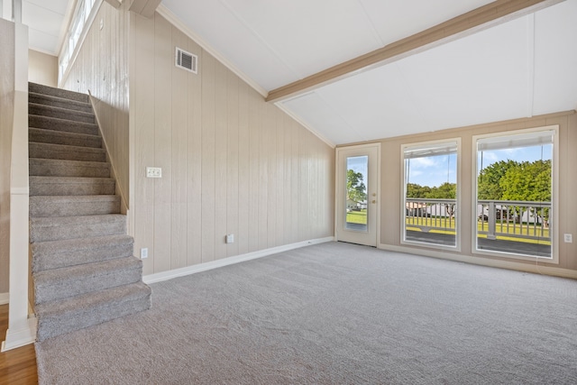 381 N Shady Oaks Dr, Point Blank, TX 77364 - unfurnished living room featuring stairway, baseboards, wood walls, and carpet