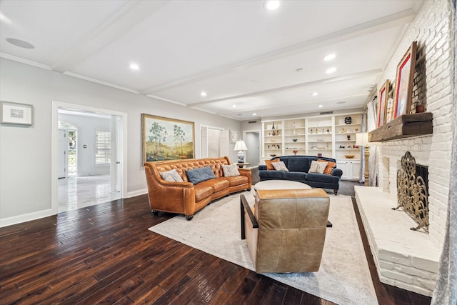 living area with hardwood / wood-style floors, beamed ceiling, baseboards, a fireplace, and crown molding