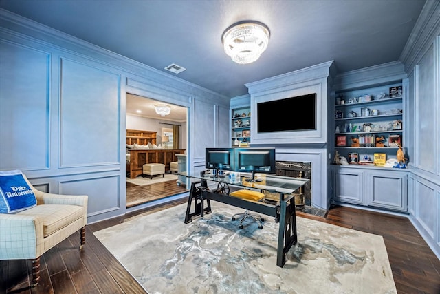home office with a decorative wall, dark wood-type flooring, and ornamental molding