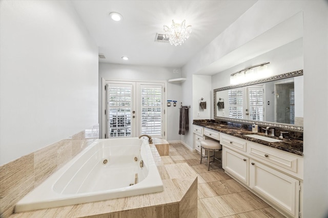 full bath with a jetted tub, a chandelier, a shower stall, vanity, and recessed lighting