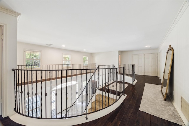 hallway featuring an upstairs landing, hardwood / wood-style floors, and recessed lighting