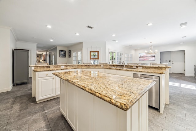 kitchen with a large island, stainless steel dishwasher, a sink, baseboards, and recessed lighting