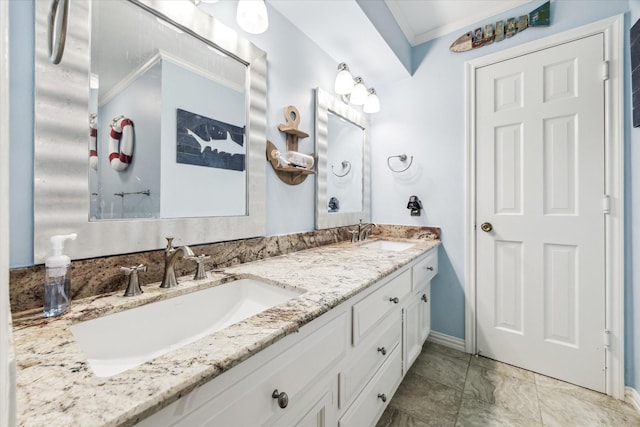 bathroom featuring crown molding, double vanity, and baseboards