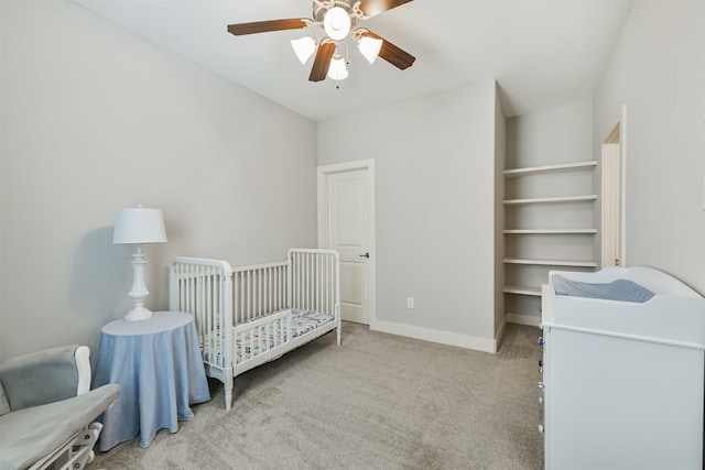 bedroom featuring light carpet, ceiling fan, and baseboards