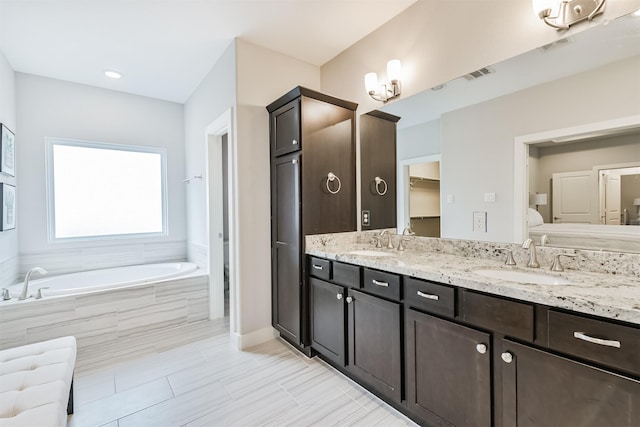 full bath with a bath, double vanity, a closet, and tile patterned floors