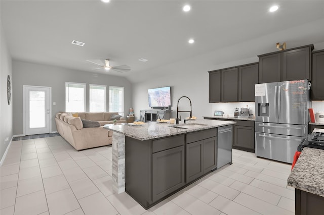 11510 Gingerland Dr, Conroe, TX 77304 - kitchen featuring stainless steel appliances, ceiling fan, a sink, light tile patterned floors, and recessed lighting