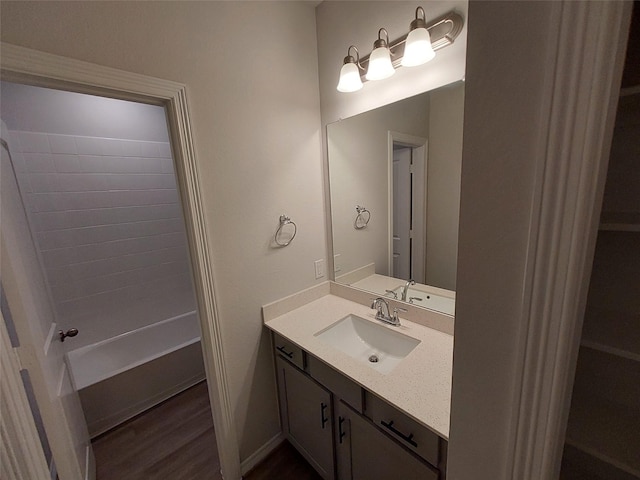 bathroom featuring vanity, wood finished floors, and shower / bath combination