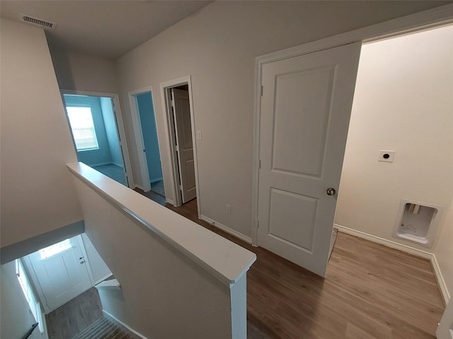 corridor with dark wood finished floors and baseboards