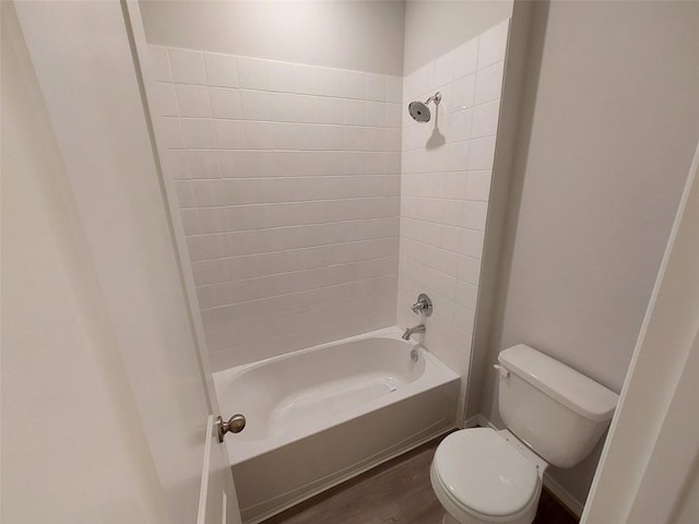 full bathroom featuring toilet, wood finished floors, and shower / washtub combination