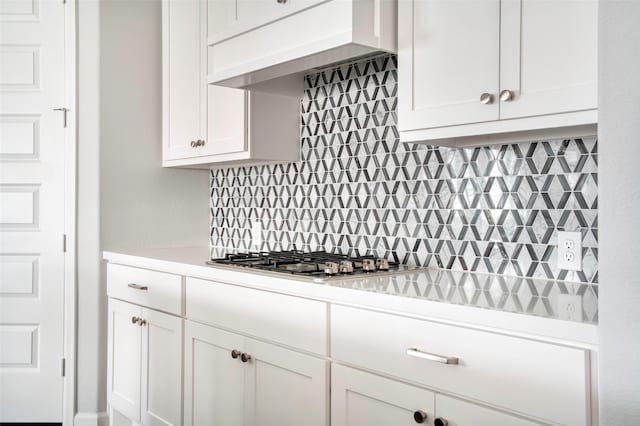 30142 Gold Finch Pl, Fulshear, TX 77441 - kitchen featuring exhaust hood, stainless steel gas cooktop, light countertops, backsplash, and white cabinets