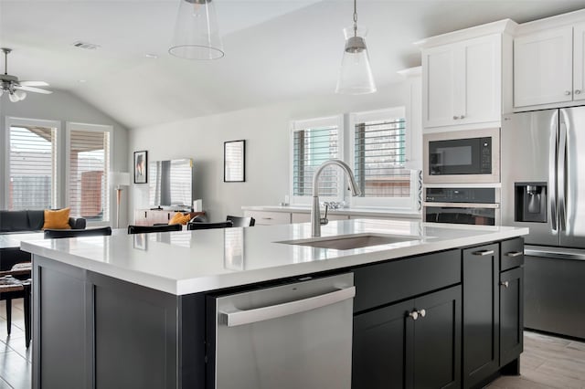 30142 Gold Finch Pl, Fulshear, TX 77441 - kitchen with appliances with stainless steel finishes, a sink, lofted ceiling, open floor plan, and a center island with sink