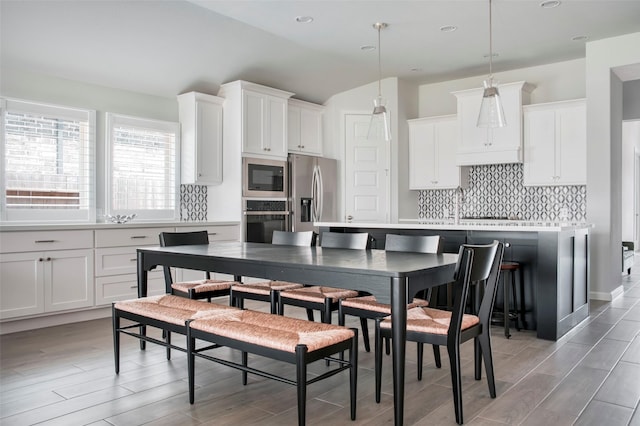 30142 Gold Finch Pl, Fulshear, TX 77441 - kitchen featuring appliances with stainless steel finishes, backsplash, light wood-style flooring, white cabinets, and recessed lighting