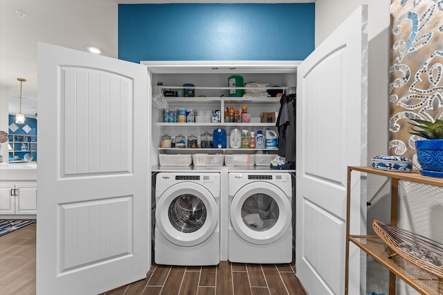 6804 Westview Dr Unit 2207, Houston, TX 77055 - washroom featuring dark wood finished floors and washer and dryer
