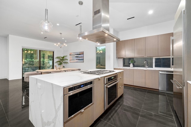 kitchen with appliances with stainless steel finishes, modern cabinets, island range hood, a large island, and decorative light fixtures