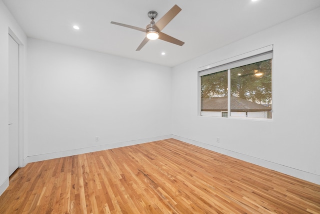 spare room featuring wood finished floors, recessed lighting, ceiling fan, and baseboards