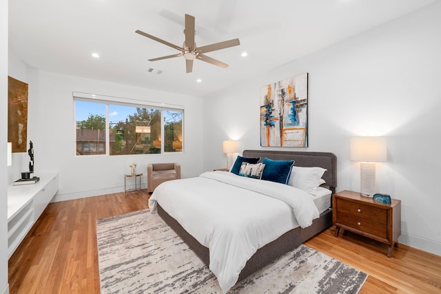 bedroom with wood finished floors, baseboards, recessed lighting, and a ceiling fan