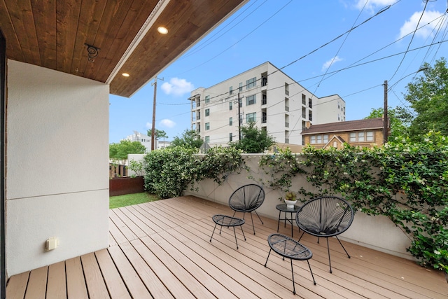 wooden terrace featuring fence