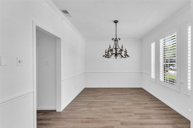16219 Haden Crest Ct, Cypress, TX 77429 - unfurnished dining area with ornamental molding, light wood finished floors, a chandelier, and baseboards