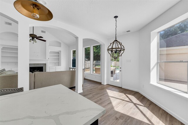 16219 Haden Crest Ct, Cypress, TX 77429 - dining area with a ceiling fan, healthy amount of natural light, wood finished floors, and built in features