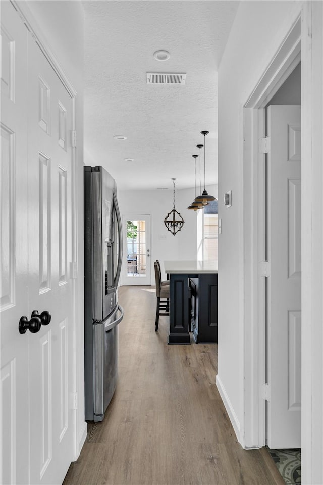 16219 Haden Crest Ct, Cypress, TX 77429 - hall featuring wood finished floors, a textured ceiling, and baseboards