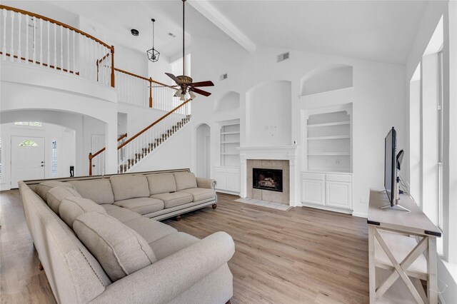 16219 Haden Crest Ct, Cypress, TX 77429 - living room with arched walkways, ceiling fan, built in features, wood finished floors, and high vaulted ceiling