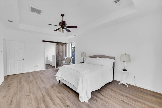 16219 Haden Crest Ct, Cypress, TX 77429 - bedroom with a raised ceiling, wood finished floors, and baseboards