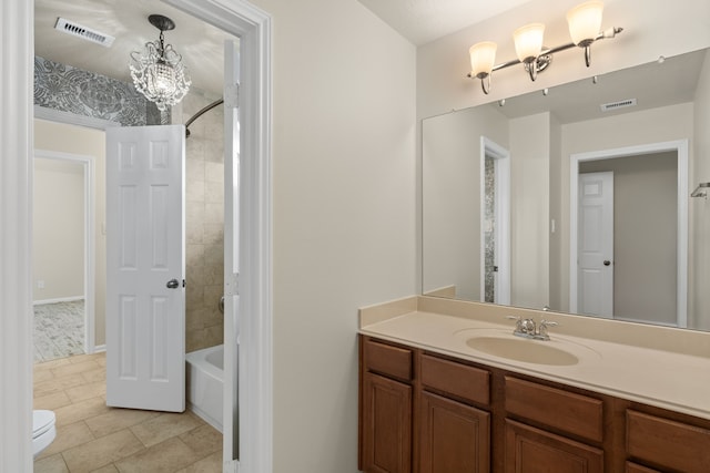 full bathroom featuring toilet, a chandelier, tile patterned floors, tub / shower combination, and vanity