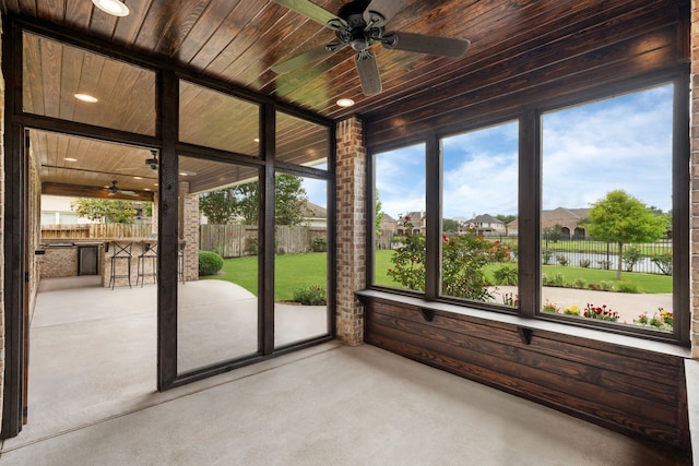 unfurnished sunroom featuring plenty of natural light and a water view