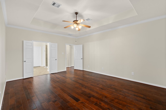 unfurnished bedroom featuring a raised ceiling, wood-type flooring, baseboards, ornamental molding, and ceiling fan