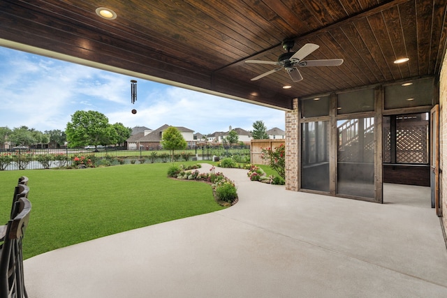 view of patio featuring a ceiling fan and a water view