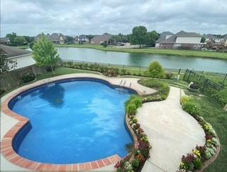 view of pool with fence and a water view