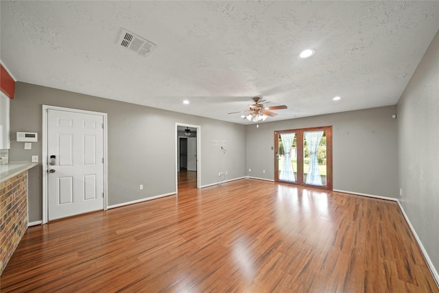 21410 Glenbranch Dr, Spring, TX 77388 - unfurnished living room with a ceiling fan, wood finished floors, a textured ceiling, baseboards, and recessed lighting