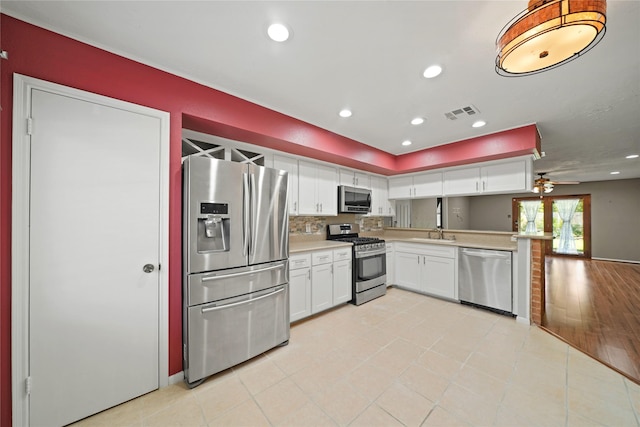 21410 Glenbranch Dr, Spring, TX 77388 - kitchen with stainless steel appliances, light countertops, white cabinetry, a ceiling fan, and recessed lighting