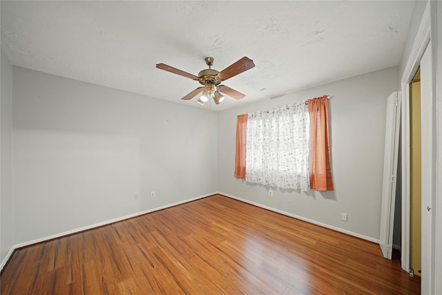 21410 Glenbranch Dr, Spring, TX 77388 - unfurnished room with wood finished floors, ceiling fan, and baseboards