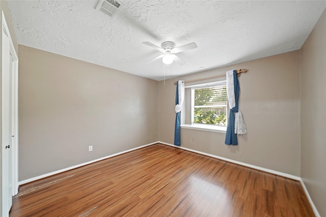 21410 Glenbranch Dr, Spring, TX 77388 - spare room with wood finished floors, baseboards, a ceiling fan, and a textured ceiling