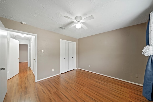 21410 Glenbranch Dr, Spring, TX 77388 - unfurnished bedroom featuring attic access, wood finished floors, baseboards, a closet, and a textured ceiling