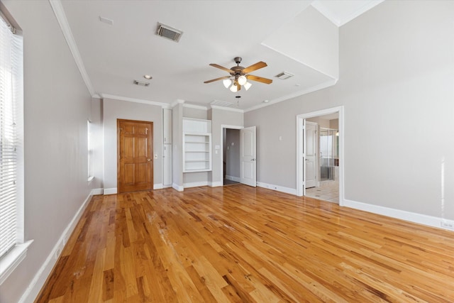 unfurnished bedroom with light wood-style flooring, crown molding, baseboards, multiple windows, and ensuite bathroom