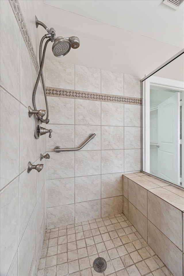 bathroom with a tile shower