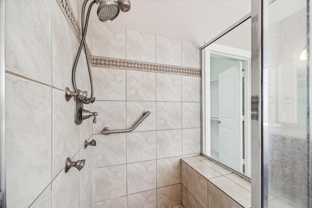 full bath with a tile shower