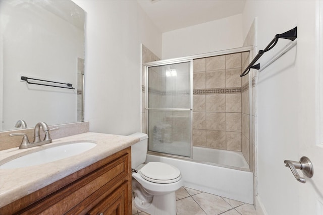 full bathroom with vanity, combined bath / shower with glass door, tile patterned flooring, and toilet