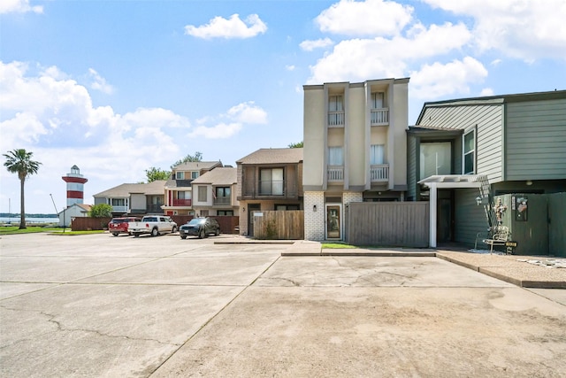 1924 Clipper Ct, Willis, TX 77318 - view of front of home featuring uncovered parking, stucco siding, a residential view, and brick siding