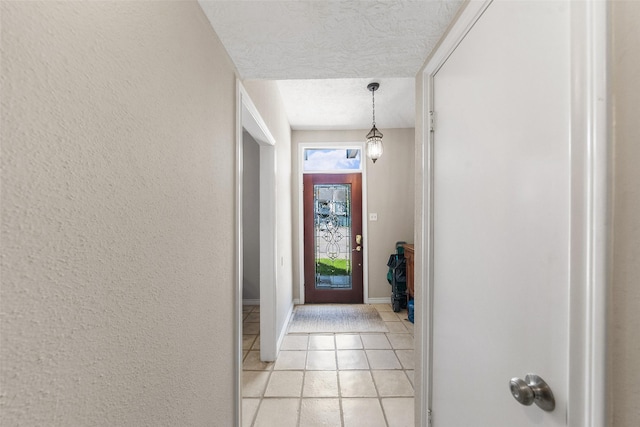 1924 Clipper Ct, Willis, TX 77318 - doorway featuring a textured ceiling, light tile patterned flooring, baseboards, and a textured wall