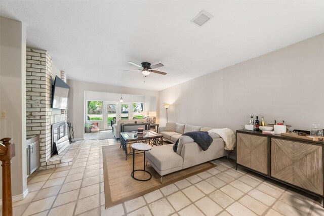 1924 Clipper Ct, Willis, TX 77318 - living room featuring a ceiling fan, a brick fireplace, and light tile patterned floors